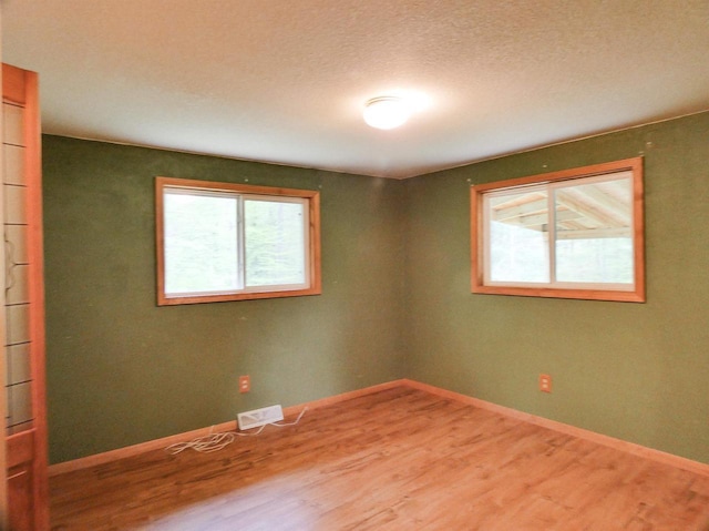 N11475 Post Lake Dr, Elcho, WI 54428 - spare room featuring healthy amount of natural light, wood finished floors, and baseboards