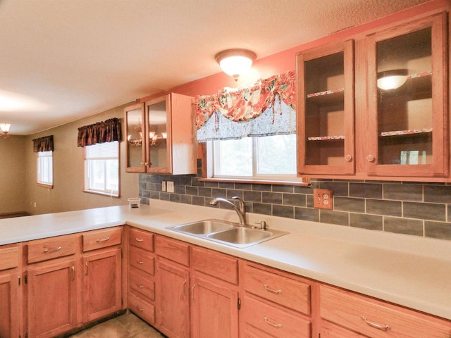 N11475 Post Lake Dr, Elcho, WI 54428 - kitchen with a sink, a peninsula, light countertops, and glass insert cabinets