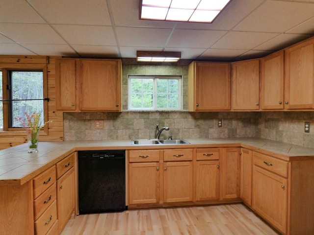N11475 Post Lake Dr, Elcho, WI 54428 - kitchen featuring black dishwasher, a sink, a peninsula, light wood finished floors, and a paneled ceiling