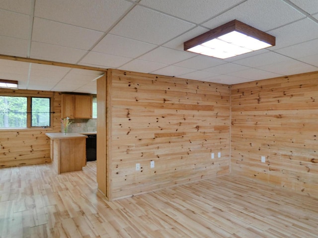 N11475 Post Lake Dr, Elcho, WI 54428 - unfurnished room with wooden walls, a paneled ceiling, and light wood-style flooring