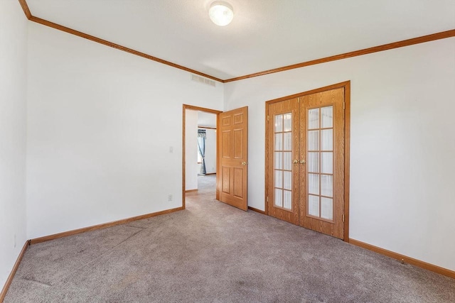 2701 E Main St Unit 136, Reedsburg, WI 53959 - spare room with carpet flooring, ornamental molding, baseboards, and french doors