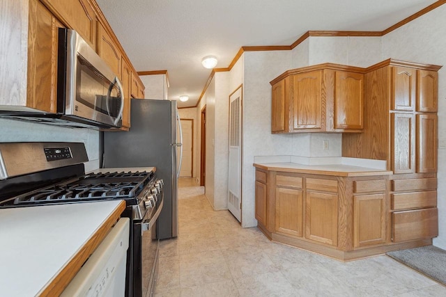 2701 E Main St Unit 136, Reedsburg, WI 53959 - kitchen with appliances with stainless steel finishes, crown molding, and light countertops