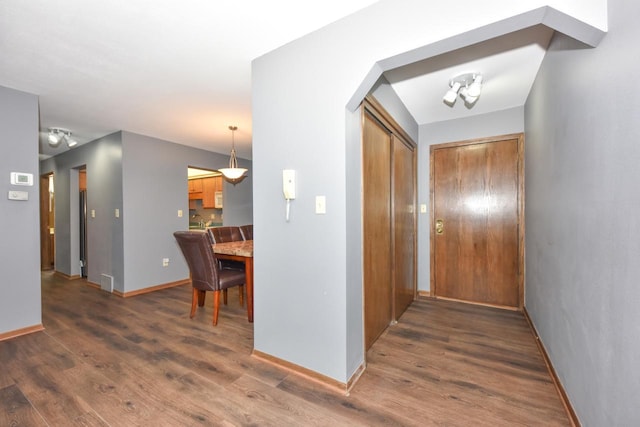 6575 N Green Bay Ave Unit 211, Glendale, WI 53209 - hall featuring wood finished floors, baseboards, and arched walkways
