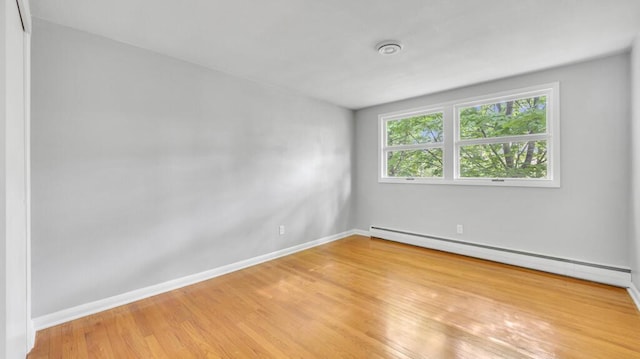 1007 Forest Hill Dr, Green Bay, WI 54311 - spare room featuring baseboard heating, light wood-style flooring, and baseboards