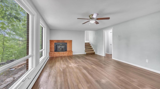 1007 Forest Hill Dr, Green Bay, WI 54311 - unfurnished living room with wood finished floors, stairway, ceiling fan, and baseboards