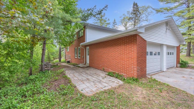 1007 Forest Hill Dr, Green Bay, WI 54311 - view of home's exterior with brick siding and an attached garage