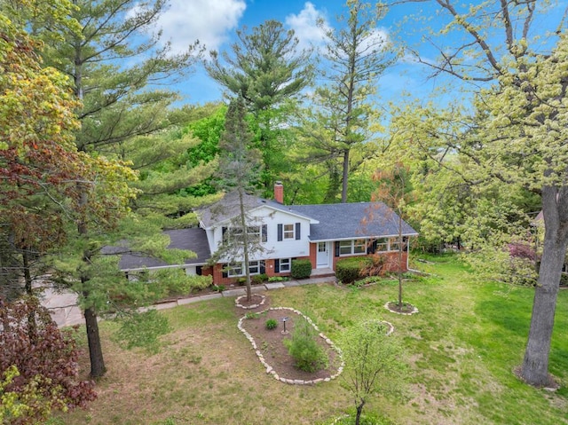 1007 Forest Hill Dr, Green Bay, WI 54311 - tri-level home with a front lawn, brick siding, and a chimney