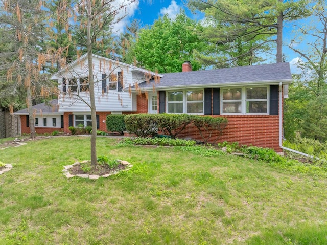 1007 Forest Hill Dr, Green Bay, WI 54311 - split level home featuring brick siding, a chimney, and a front yard
