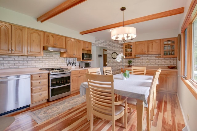 1349 93rd Ave, Kenosha, WI 53144 - kitchen featuring stainless steel appliances, under cabinet range hood, light wood-type flooring, light countertops, and a chandelier