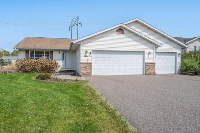 5406 Rock Rapids Dr, Weston, WI 54476 - ranch-style house with brick siding, driveway, an attached garage, a front yard, and a shingled roof