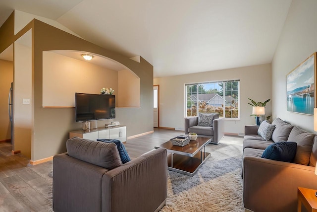 5406 Rock Rapids Dr, Weston, WI 54476 - living room featuring wood finished floors, lofted ceiling, baseboards, and arched walkways