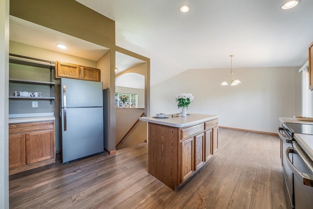 5406 Rock Rapids Dr, Weston, WI 54476 - kitchen with appliances with stainless steel finishes, brown cabinetry, dark wood finished floors, a chandelier, and lofted ceiling