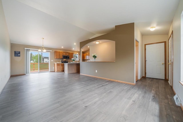 5406 Rock Rapids Dr, Weston, WI 54476 - unfurnished living room with light wood-style floors, lofted ceiling, baseboards, a chandelier, and recessed lighting
