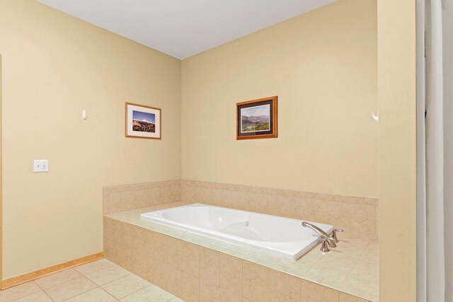 115 E Broadway Unit 210, Monona, WI 53716 - full bathroom featuring a garden tub, tile patterned floors, and baseboards