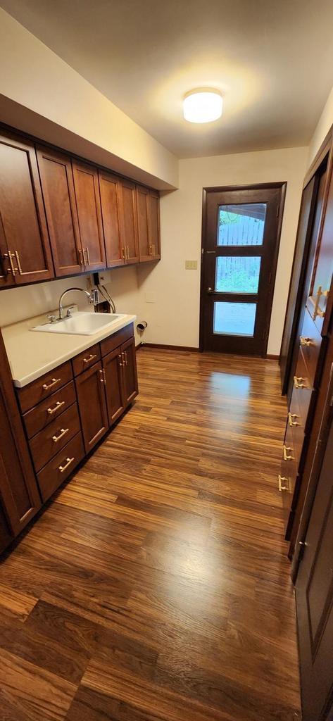 3315 N 12th St, Wausau, WI 54403 - kitchen with a sink, dark wood-style floors, and light countertops