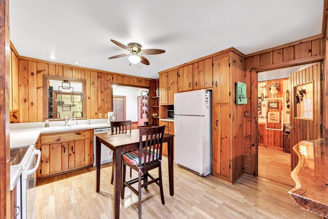 N7119 River Dr, Shawano, WI 54166 - kitchen with white appliances, wood walls, ceiling fan, light countertops, and light wood-style floors