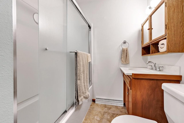 N7119 River Dr, Shawano, WI 54166 - bathroom with toilet, a baseboard heating unit, vanity, and combined bath / shower with glass door
