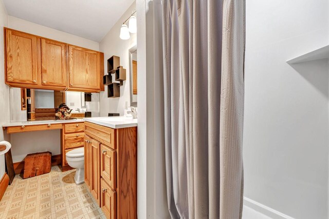 N7119 River Dr, Shawano, WI 54166 - kitchen featuring light countertops, a sink, brown cabinets, and light floors