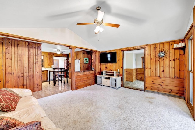 N7119 River Dr, Shawano, WI 54166 - carpeted living room featuring ceiling fan, vaulted ceiling, and wood walls