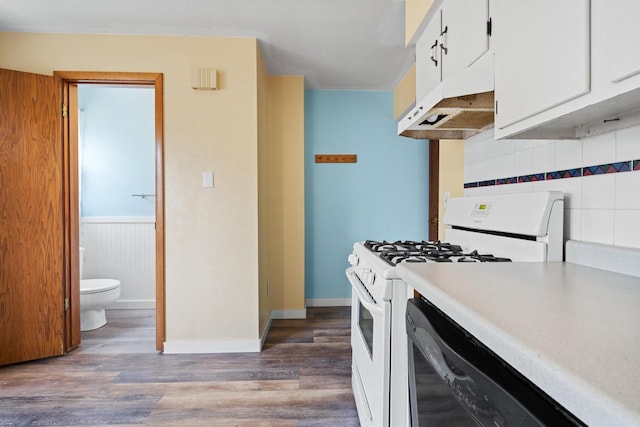 1416 21st Ave S, Wisconsin Rapids, WI 54495 - kitchen featuring white gas stove, wood finished floors, white cabinets, decorative backsplash, and under cabinet range hood