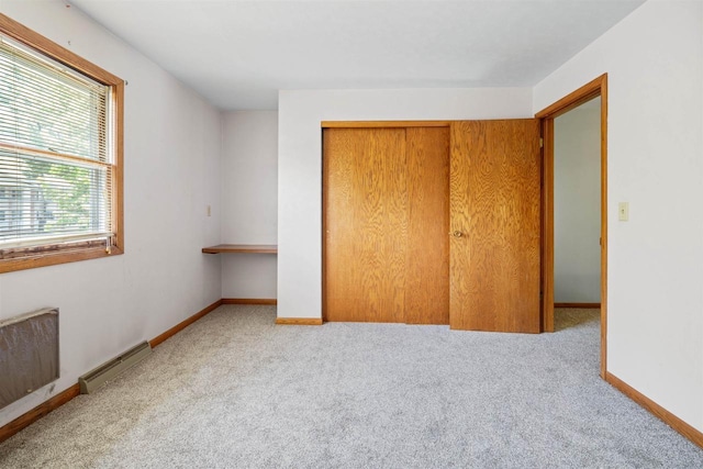 1416 21st Ave S, Wisconsin Rapids, WI 54495 - unfurnished bedroom with carpet flooring, a baseboard radiator, a closet, and baseboards