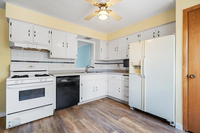 1416 21st Ave S, Wisconsin Rapids, WI 54495 - kitchen with white appliances, under cabinet range hood, a sink, dark wood-style flooring, and light countertops