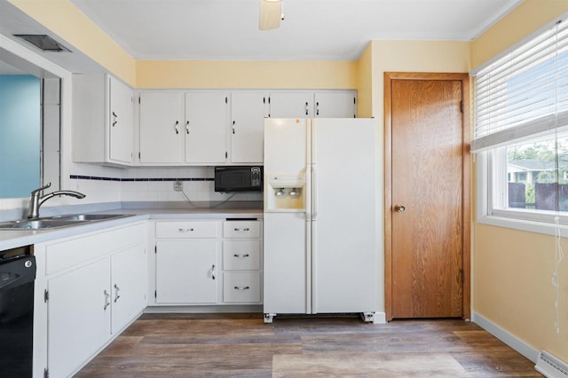 1416 21st Ave S, Wisconsin Rapids, WI 54495 - kitchen featuring black appliances, a sink, a baseboard heating unit, white cabinetry, and wood finished floors