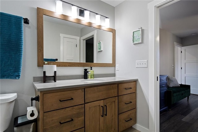 118 Dunn St, Colfax, WI 54730 - bathroom with vanity, toilet, wood finished floors, and baseboards