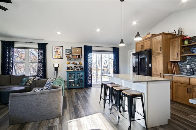 118 Dunn St, Colfax, WI 54730 - kitchen with stainless steel fridge, open shelves, healthy amount of natural light, brown cabinets, and lofted ceiling