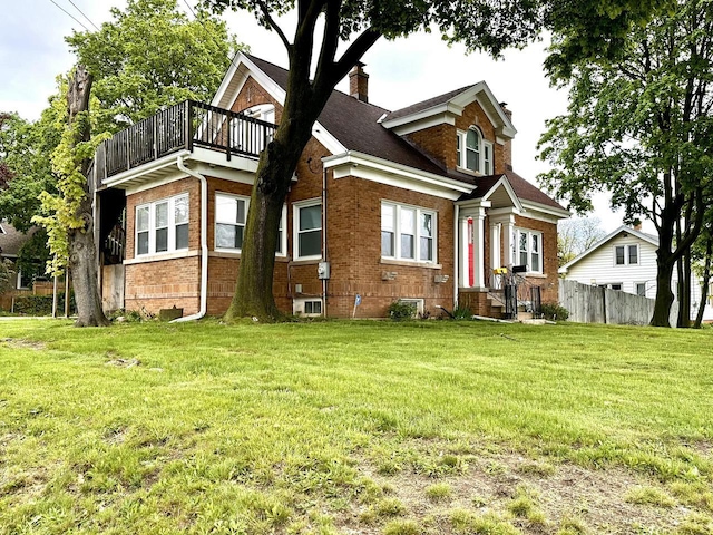 4416 75th St, Kenosha, WI 53142 - back of house with a chimney, brick siding, and a balcony