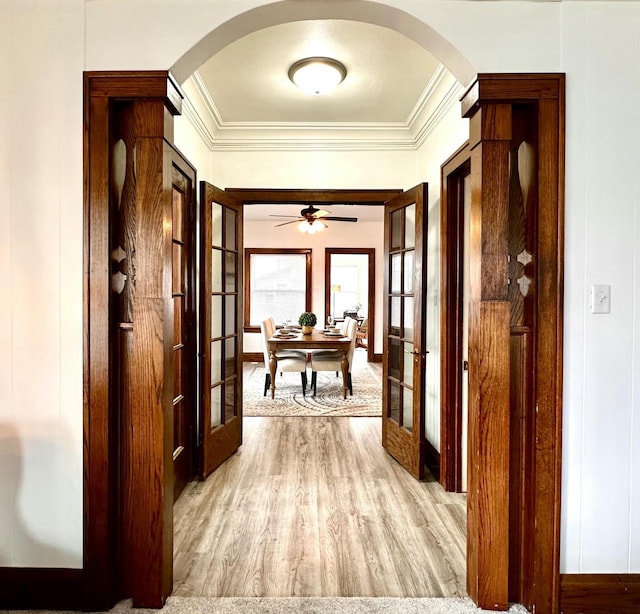 4416 75th St, Kenosha, WI 53142 - hallway featuring arched walkways, ornamental molding, wood finished floors, and french doors
