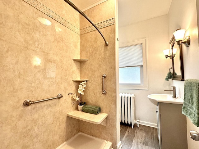 4416 75th St, Kenosha, WI 53142 - full bathroom with radiator, vanity, a shower, wood finished floors, and baseboards