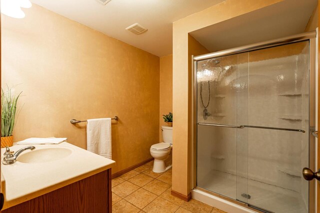 N100W14330 Sunburst Trl, Germantown, WI 53022 - bathroom featuring tile patterned flooring, toilet, a stall shower, vanity, and baseboards