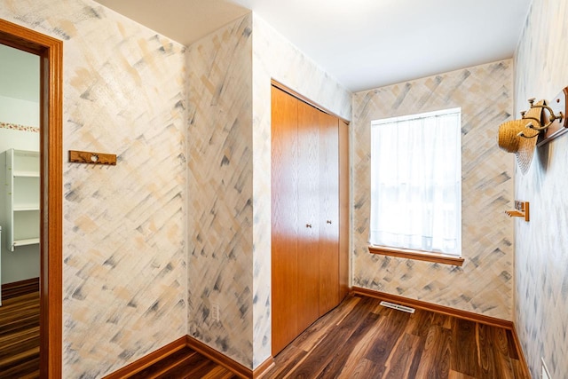 N100W14330 Sunburst Trl, Germantown, WI 53022 - unfurnished bedroom featuring wood finished floors, baseboards, a closet, and wallpapered walls