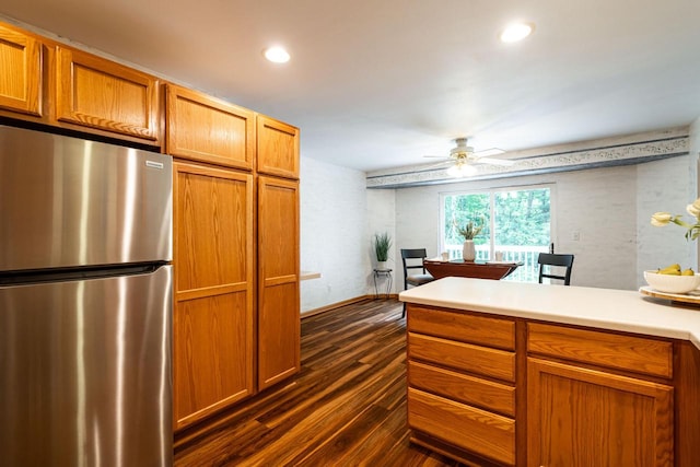 N100W14330 Sunburst Trl, Germantown, WI 53022 - kitchen with freestanding refrigerator, dark wood finished floors, brown cabinets, a ceiling fan, and light countertops
