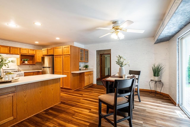N100W14330 Sunburst Trl, Germantown, WI 53022 - kitchen with freestanding refrigerator, dark wood finished floors, light countertops, under cabinet range hood, and white range with gas stovetop