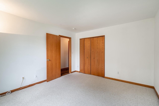 N100W14330 Sunburst Trl, Germantown, WI 53022 - unfurnished bedroom featuring carpet floors, baseboards, and a closet