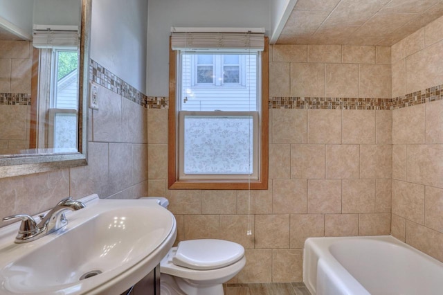 167 Po St, West Bend, WI 53090 - full bathroom with tile walls, a sink, a bath, and toilet