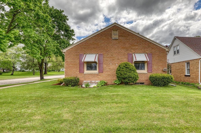 167 Po St, West Bend, WI 53090 - view of front facade with brick siding and a front lawn