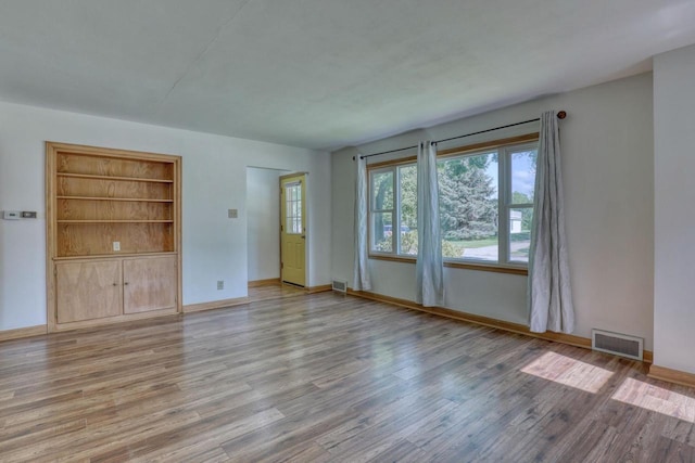 167 Po St, West Bend, WI 53090 - unfurnished room featuring wood finished floors, baseboards, and built in features