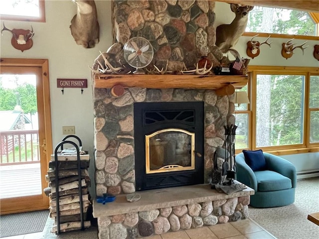 23165 Joy Villa Rd Unit 6, Glidden, WI 54527 - living room with tile patterned flooring, a fireplace, and a baseboard heating unit