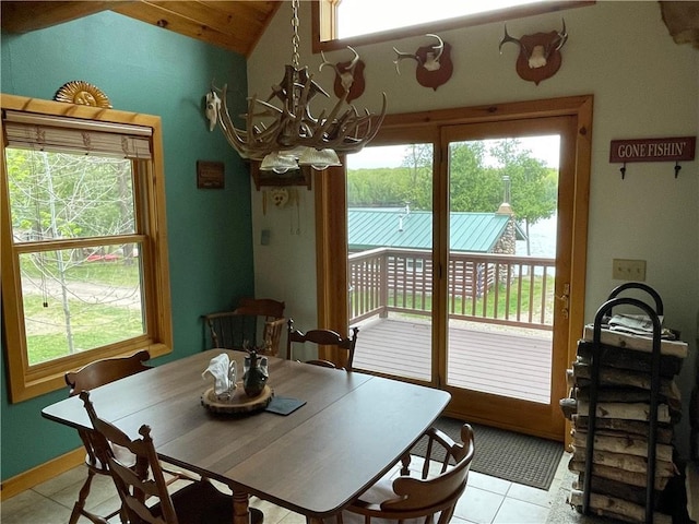 23165 Joy Villa Rd Unit 6, Glidden, WI 54527 - dining space with a chandelier, light tile patterned floors, healthy amount of natural light, and vaulted ceiling