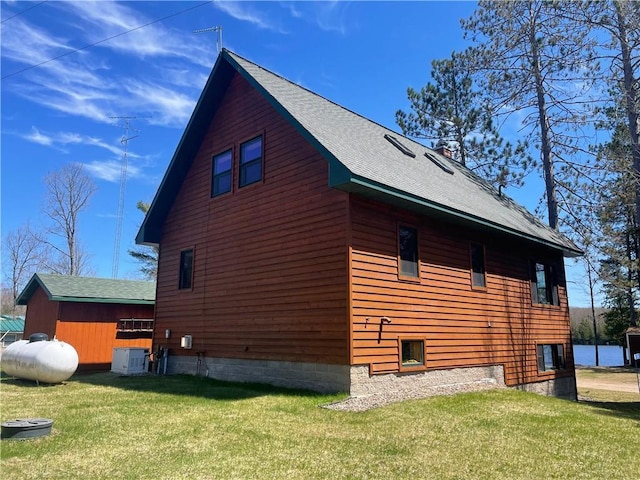 23165 Joy Villa Rd Unit 6, Glidden, WI 54527 - view of side of property with a lawn, central air condition unit, and roof with shingles