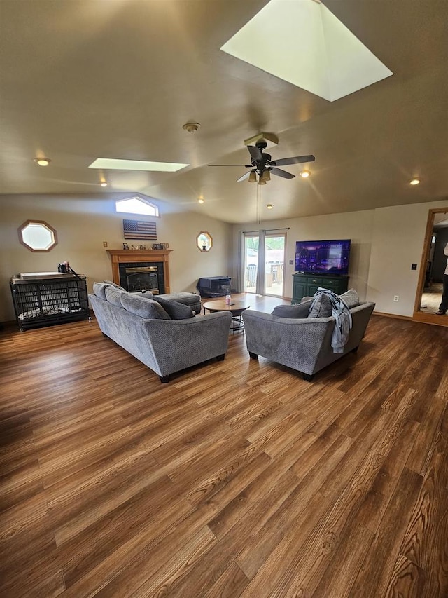 301 Superior St, Boscobel, WI 53805 - living room featuring a tiled fireplace, dark wood-style flooring, a ceiling fan, recessed lighting, and a skylight
