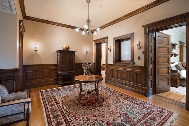 3432 N Lake Dr, Milwaukee, WI 53211 - sitting room with crown molding, wainscoting, a chandelier, and wood finished floors