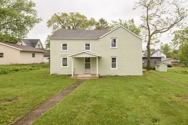 244 S Ridge St, Hustisford, WI 53034 - rear view of house featuring a yard, brick siding, a shingled roof, and a storage unit