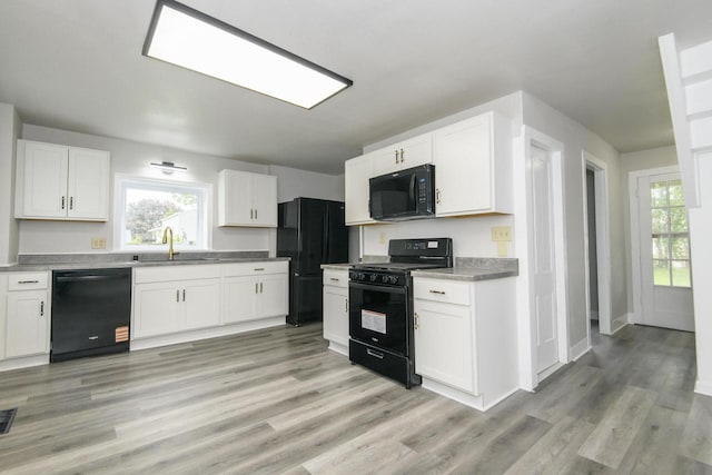 244 S Ridge St, Hustisford, WI 53034 - kitchen with black appliances, a sink, white cabinets, and healthy amount of natural light