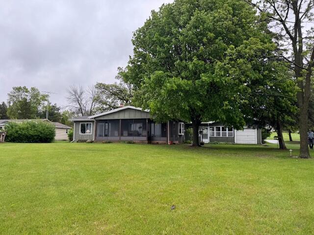 W6782 Marine Dr, Markesan, WI 53946 - view of green lawn featuring a sunroom