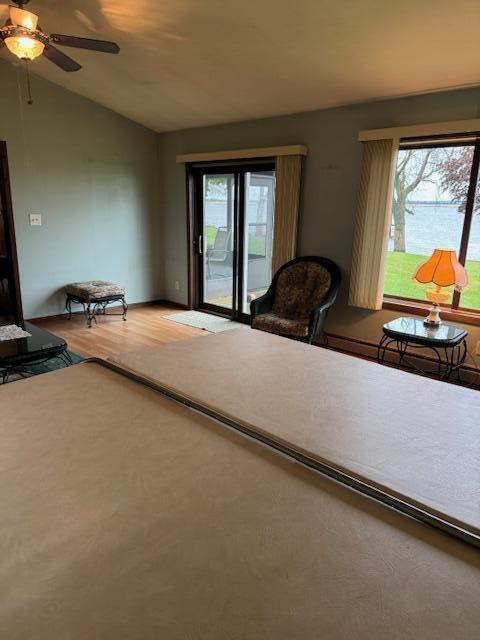 W6782 Marine Dr, Markesan, WI 53946 - living area with vaulted ceiling, a ceiling fan, and wood finished floors