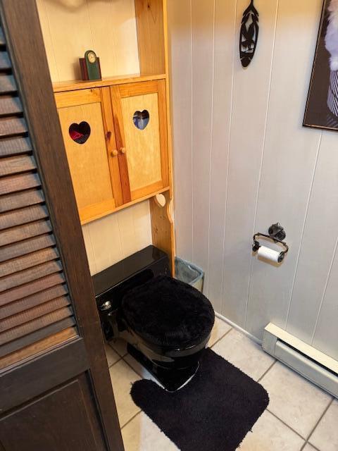 W6782 Marine Dr, Markesan, WI 53946 - bathroom with tile patterned floors, baseboard heating, toilet, and a decorative wall